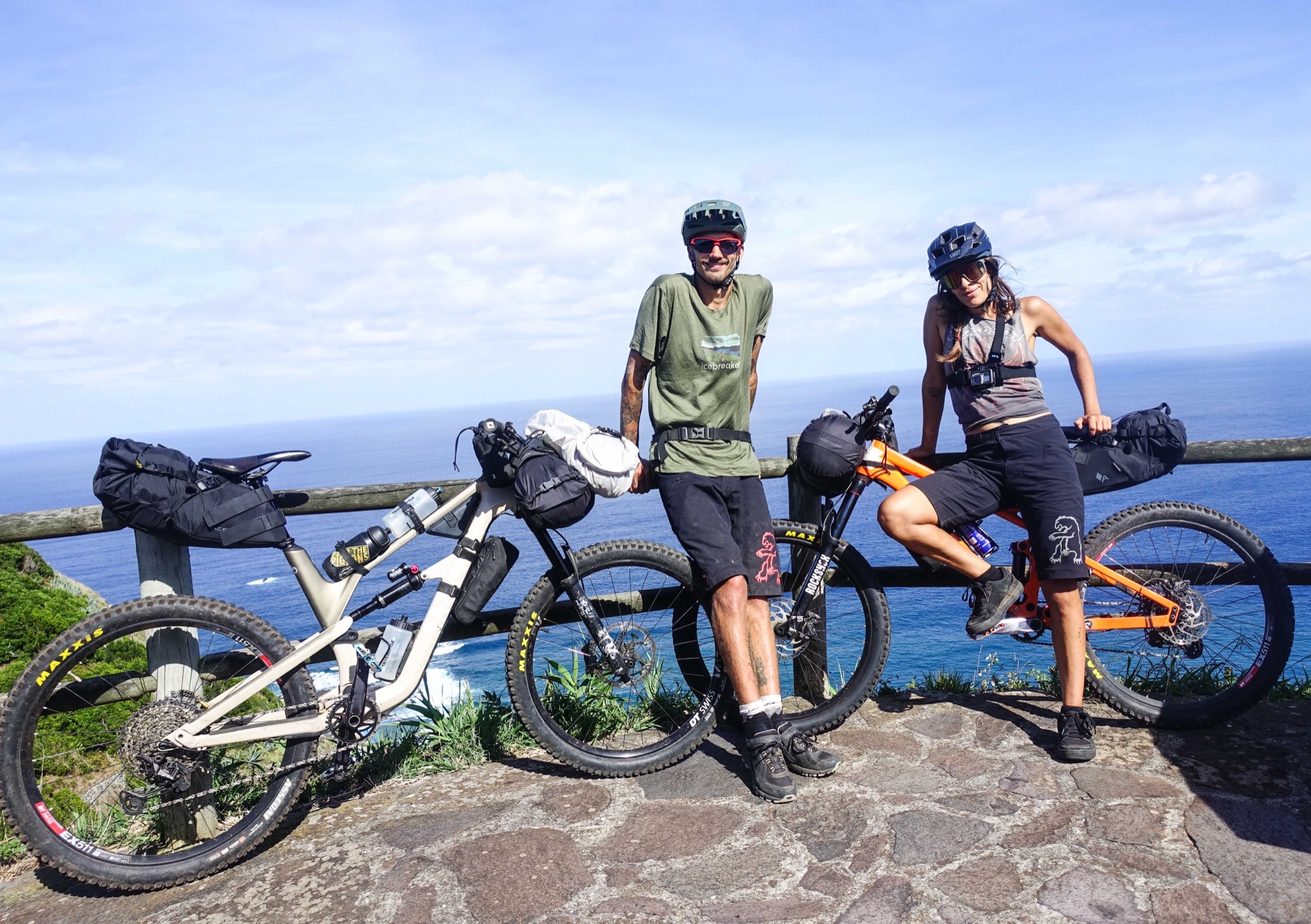 Jallas and Juliana with their loaded bikes on the coast of São Miguel